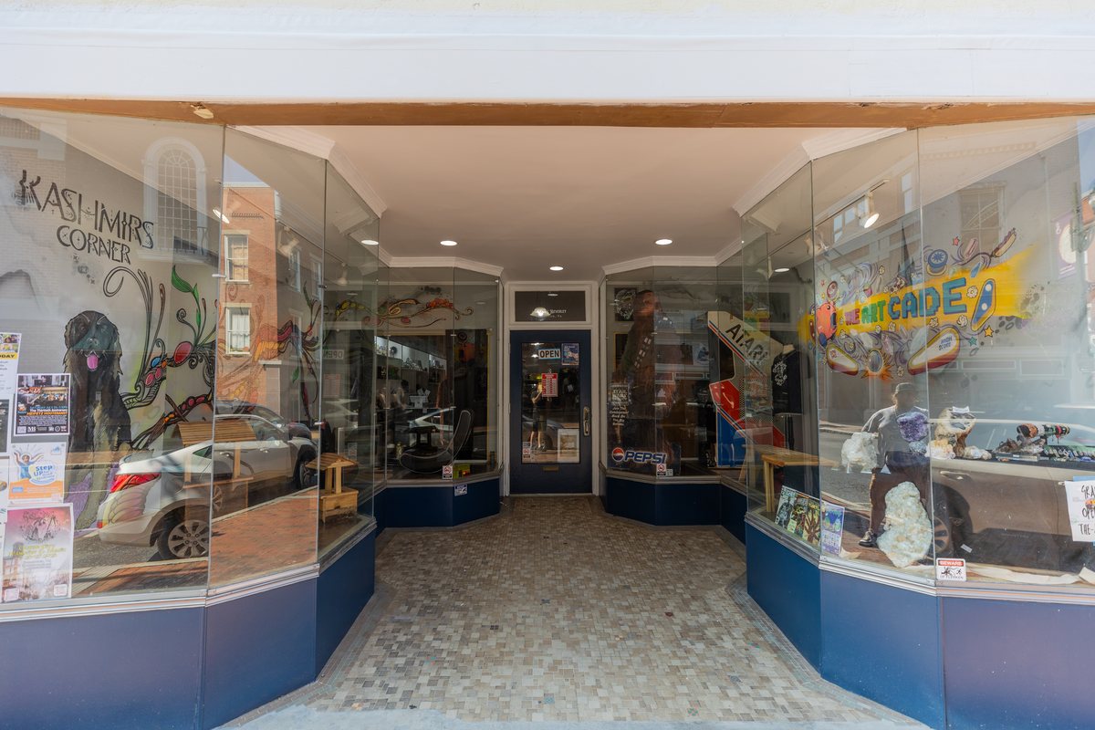 Inside The Art-Cade from the front door: display cases, the art wall and the arcade at the back