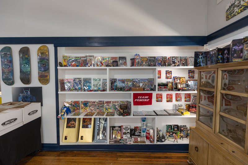 The vintage collectible and comics wall at The Art-Cade